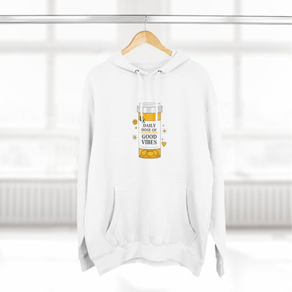 White hoodie with a daily dose of good vibes  design on a hanger against a white background