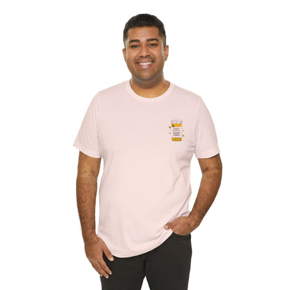 Man wearing a light pink t-shirt with a prescription bottle good vibes graphic on a white background