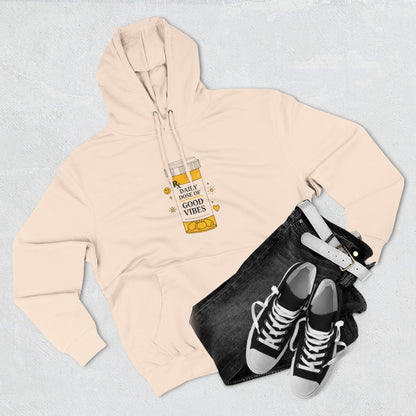 Pale Pink hoodie with a graphic design, black jeans, and black sneakers on a light gray background