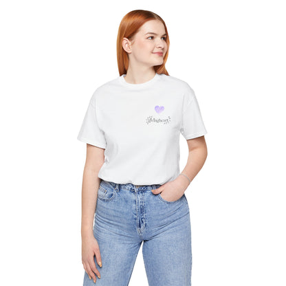 Person wearing a white t-shirt with a  lilac heart logo and blue jeans on a white background