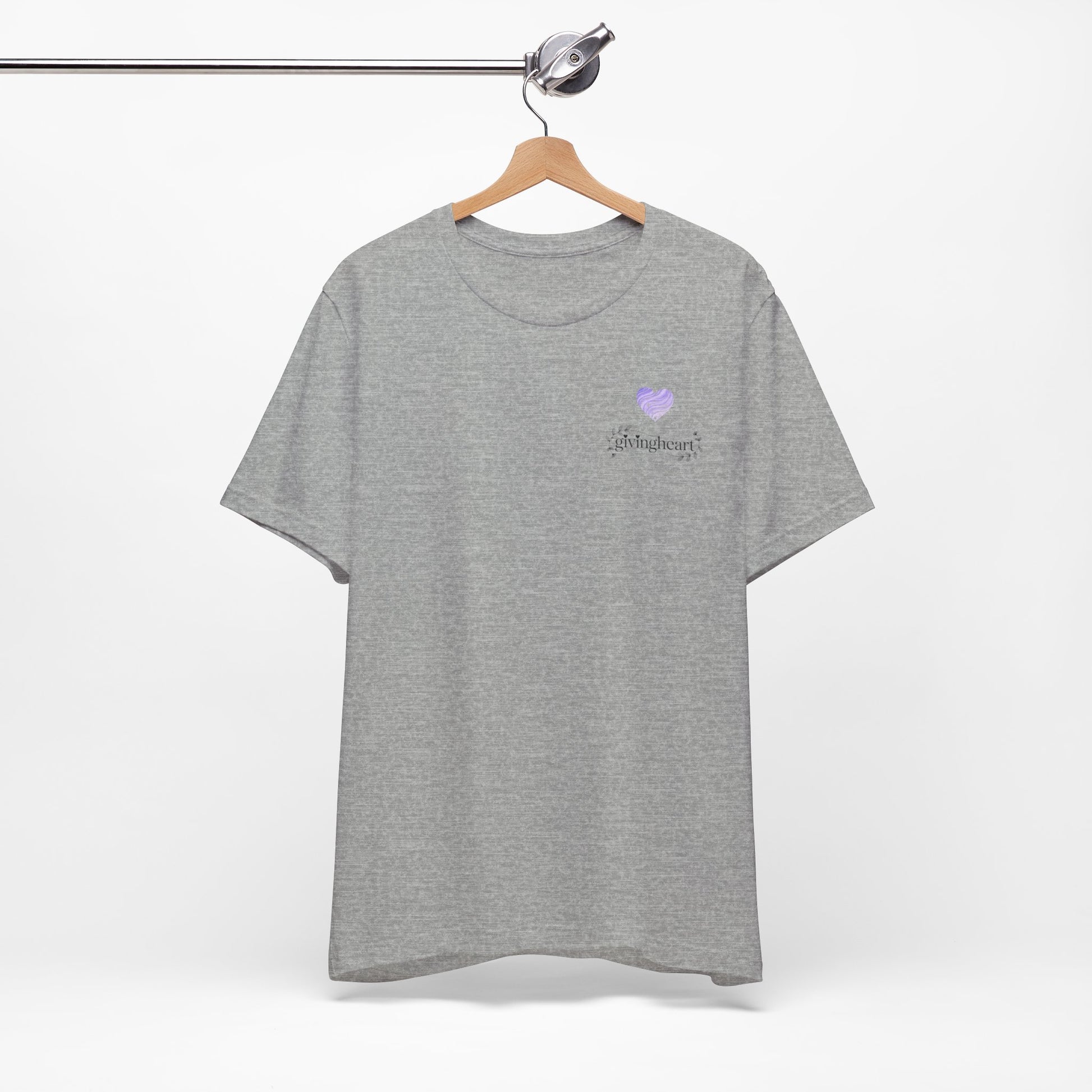 Gray t-shirt with a  lilac heart logo on a hanger against a white background