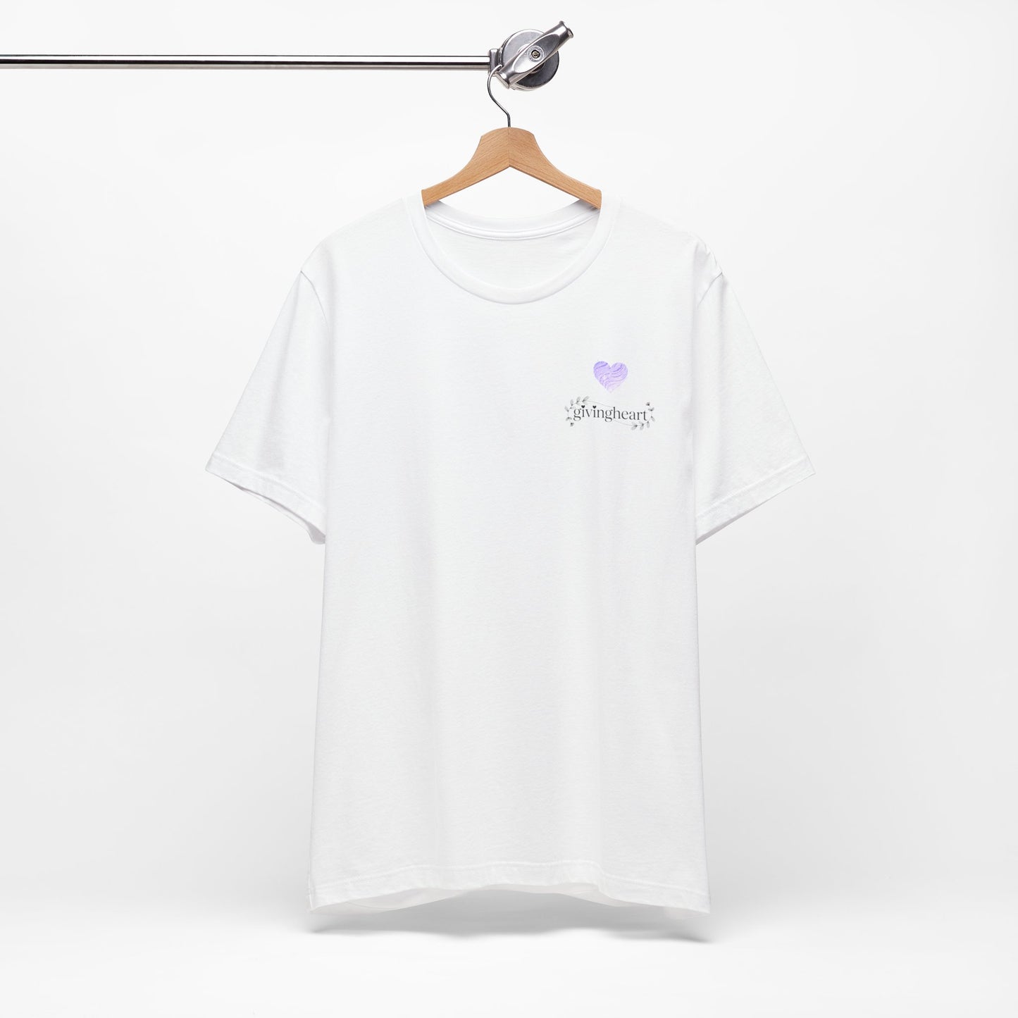 White t-shirt with a lilac heart logo on a hanger against a white background