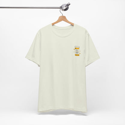 White t-shirt with a small prescription bottle good vibes  on a hanger against a white background