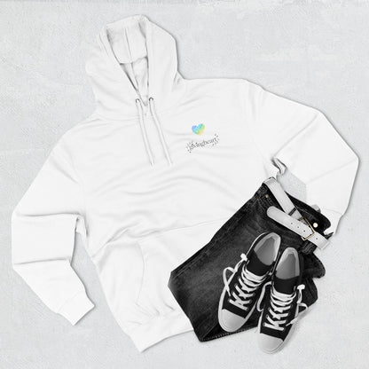 White hoodie with a blue/green/yellow heart logo logo, black jeans, and black sneakers on a light gray background