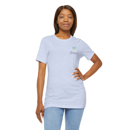 Woman wearing a light blue t-shirt with a a blue/green/yellow logo  on a white background