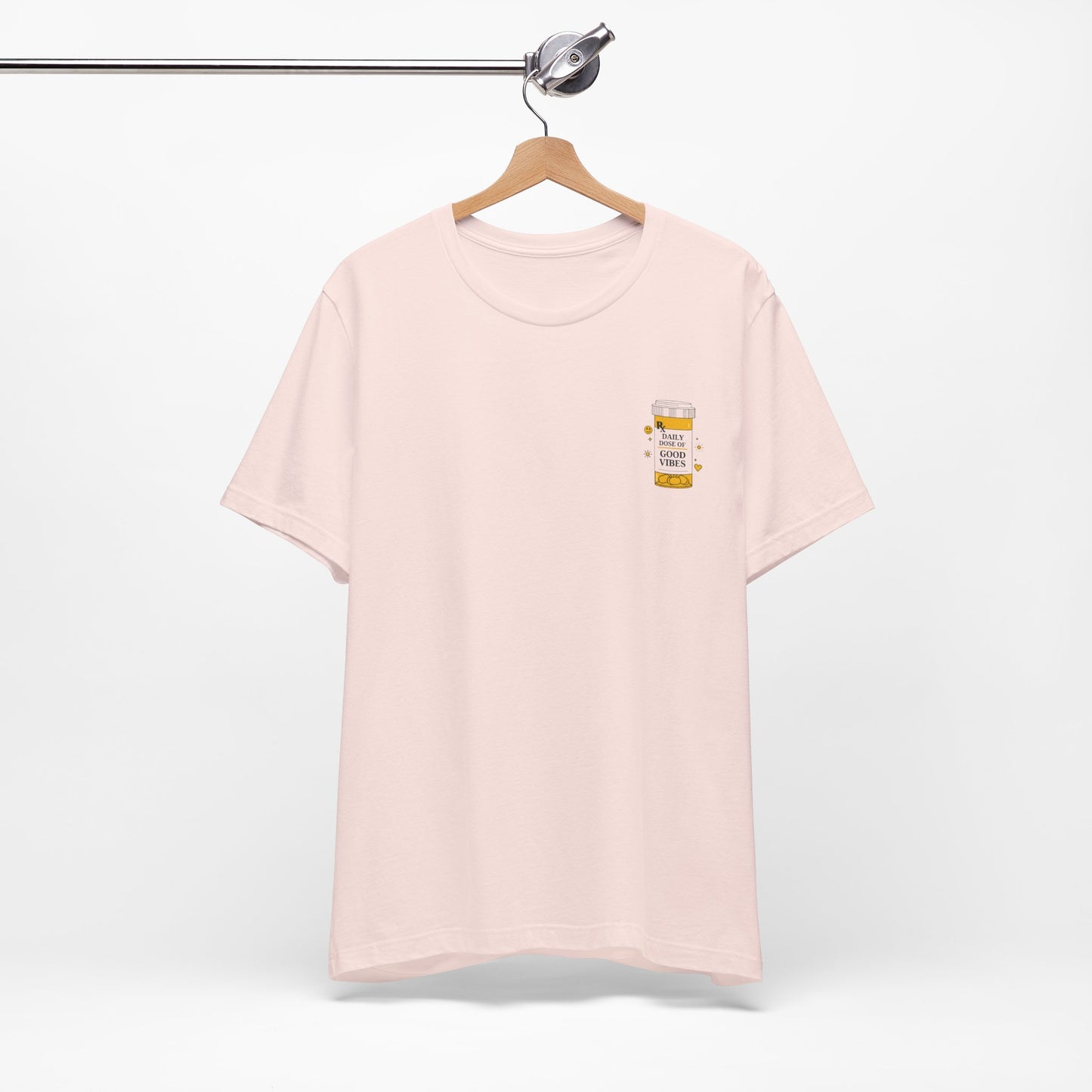Pink t-shirt with a prescription bottle good vibes  design on a hanger against a white background