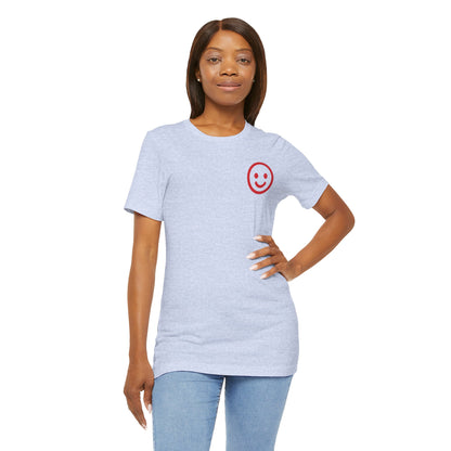 Woman wearing a light blue t-shirt with a red smiley face design on a white background