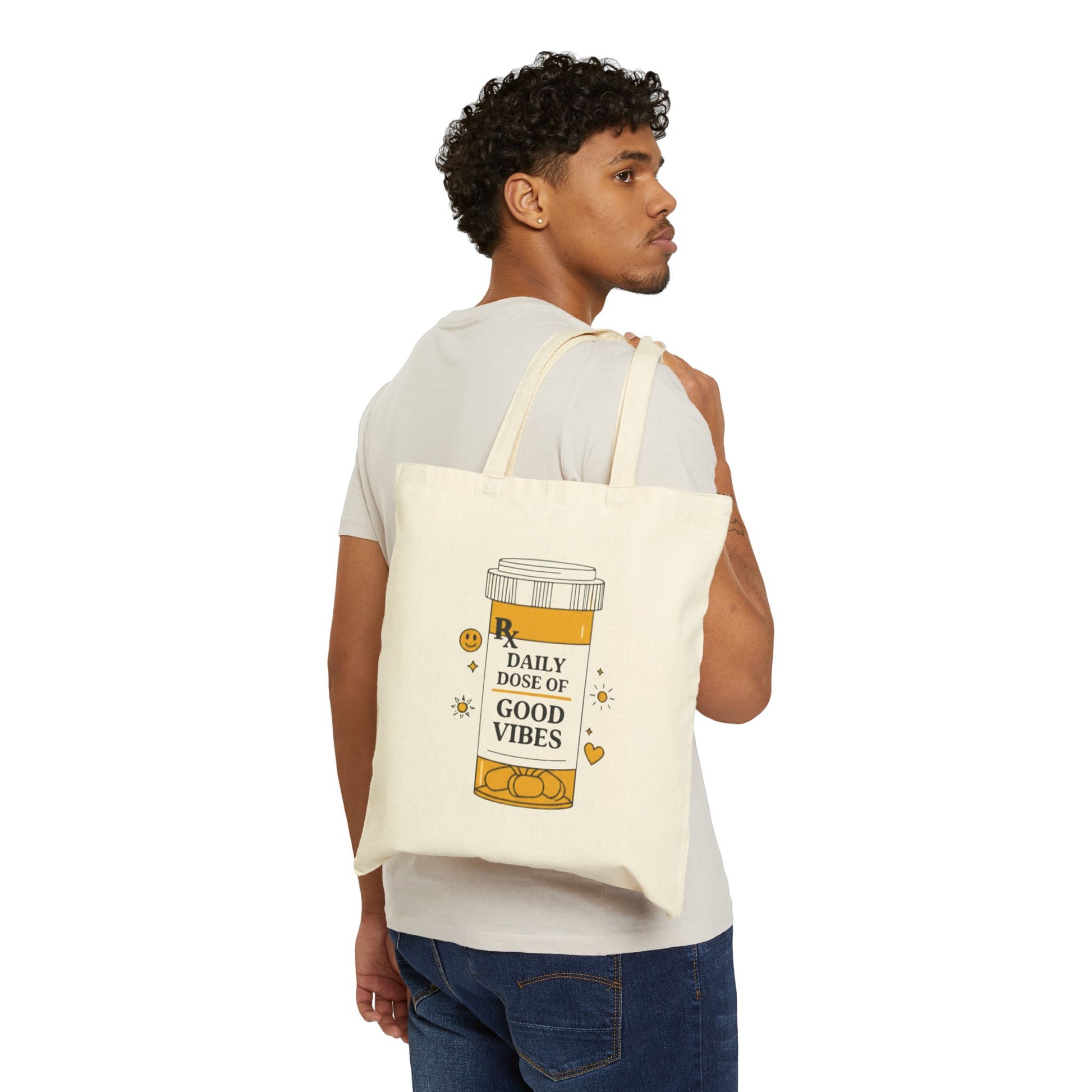 Man carrying a tote bag with a daily dose of good vibes on a white background