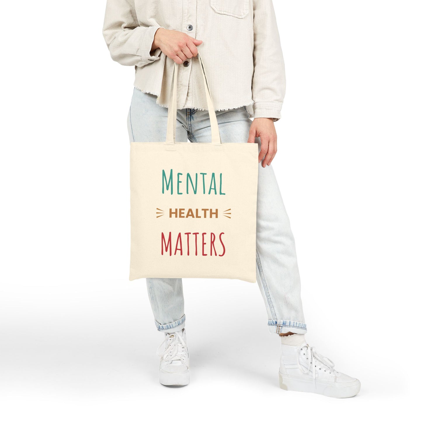 Person holding a tote bag with 'Mental Health Matters' text on a white background