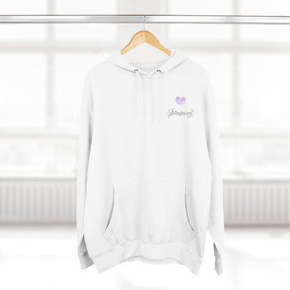 White hoodie with a lilac colored heart logo on a wooden hanger against a white background