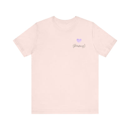Pink t-shirt with a small  lilac heart logo on a white background