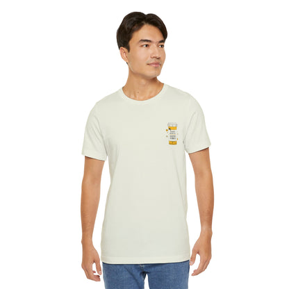 Man wearing a beige t-shirt with a small prescription bottle good vibes graphic on a white background