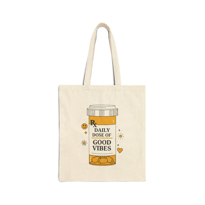 Tote bag with a design of a pill bottle labeled 'Daily Dose of Good Vibes' on a white background