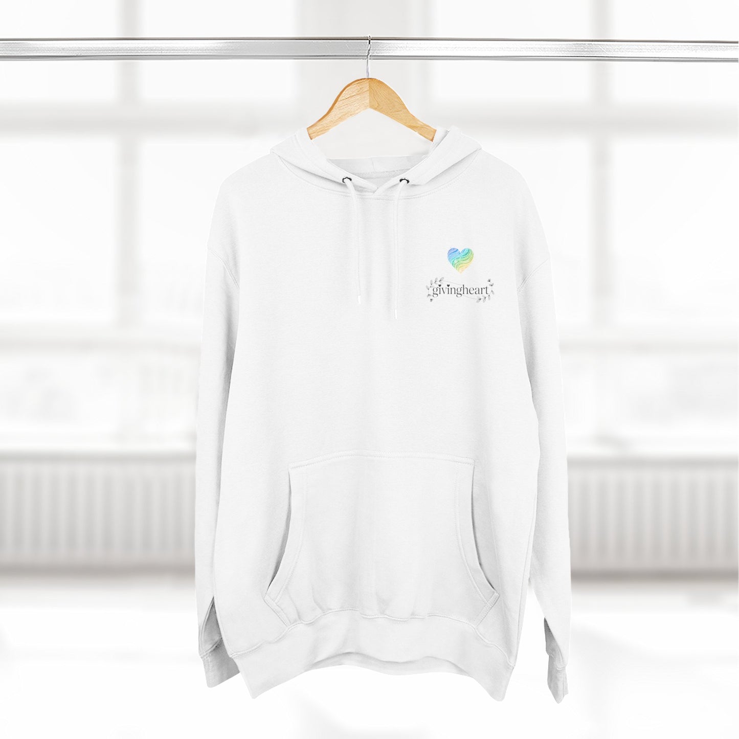 White hoodie with a blue/green/yellow heart logo logo on a wooden hanger against a white background