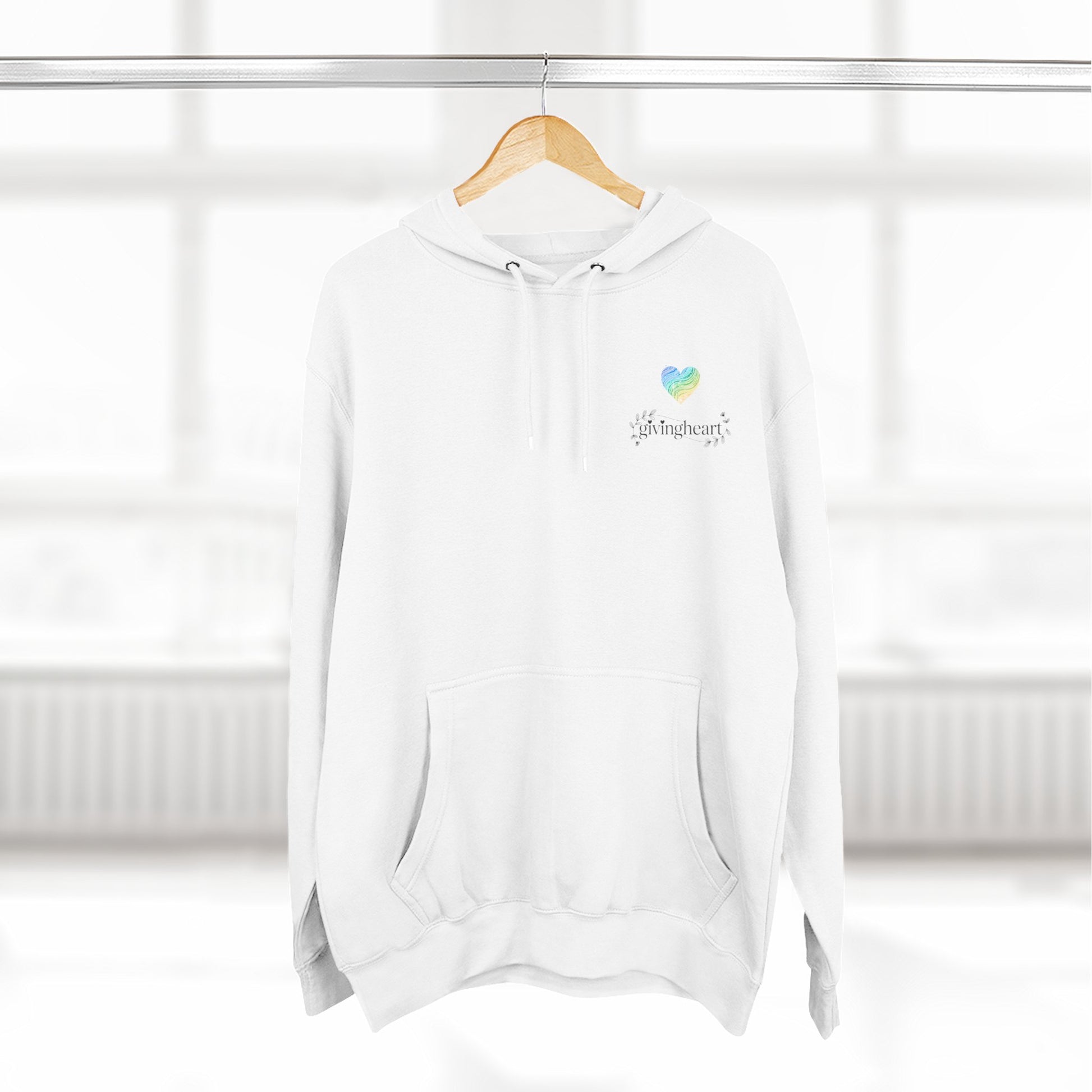 White hoodie with a blue/green/yellow heart logo logo on a wooden hanger against a white background