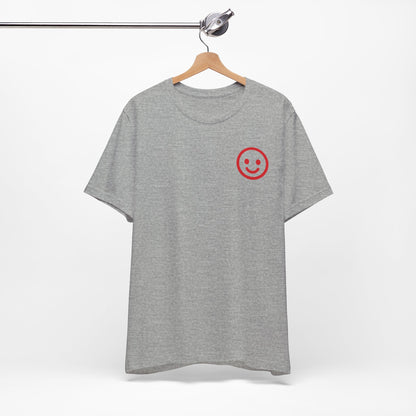 Gray t-shirt with a red smiley face on a hanger against a white background