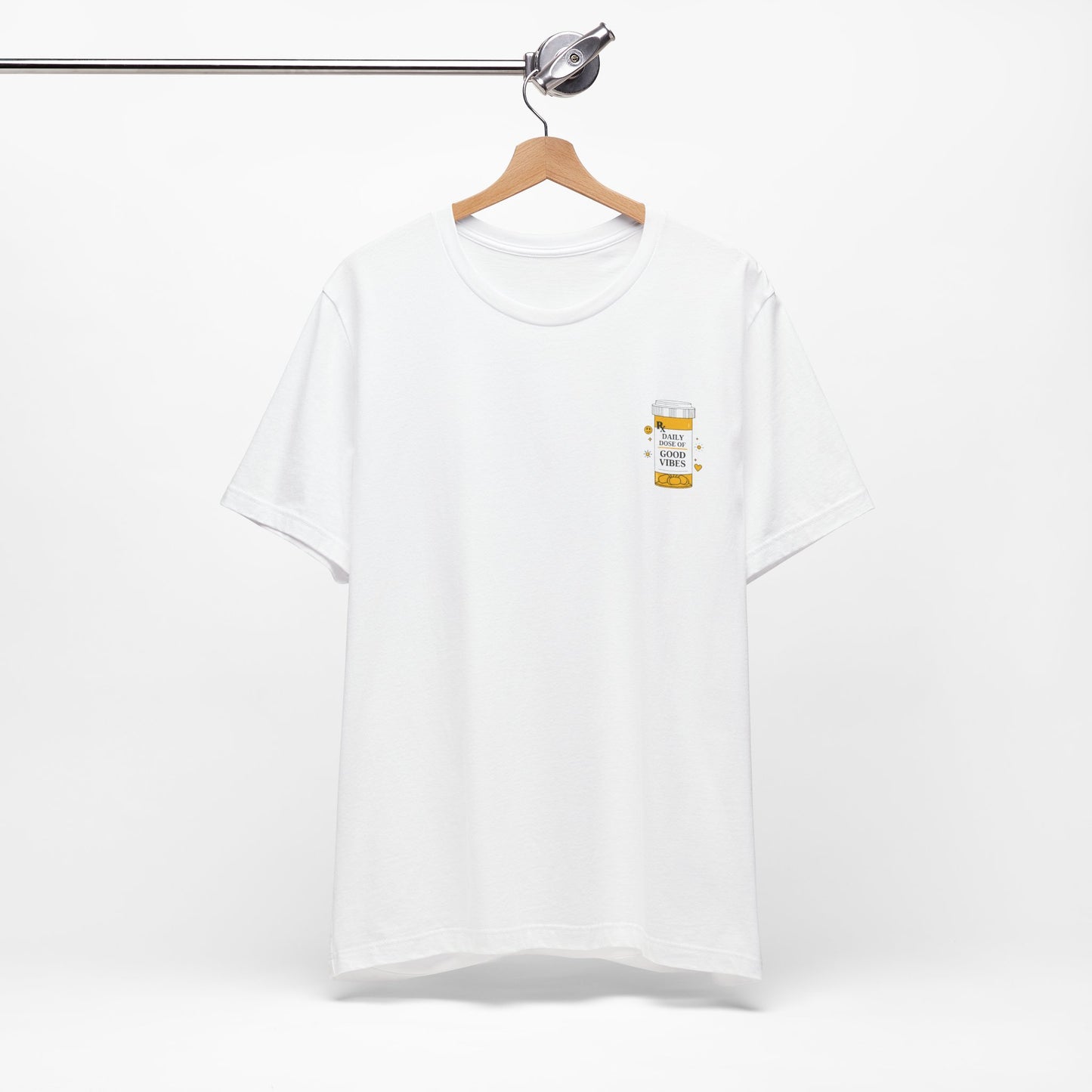 White t-shirt with a small prescription bottle good vibes graphic on a hanger against a white background