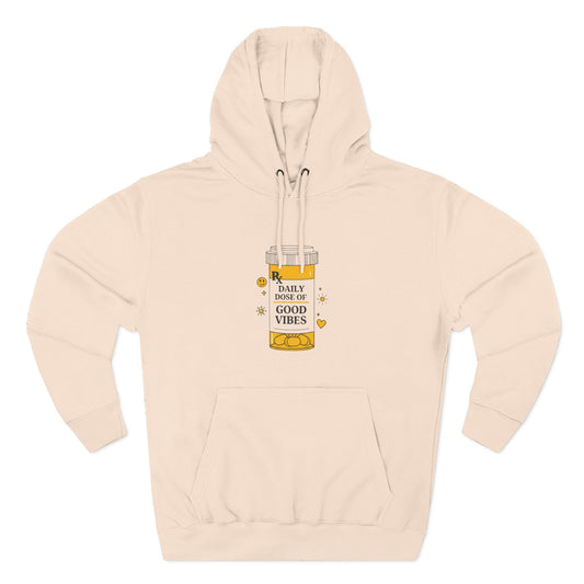 Pale pink hoodie with a graphic of a bottle labeled 'Dose of Good Vibes' on a white background